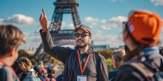 Tour guide leading group at the Eiffel Tower in Paris